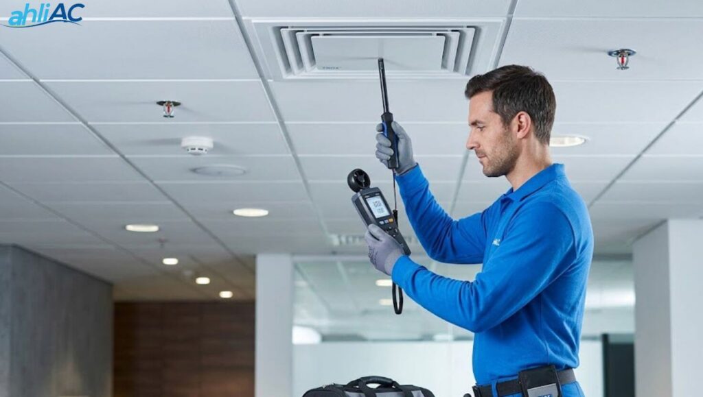hvac system maintenance and airflow test HVAC technician performing routine maintenance and airflow testing on a Trox ducting system.